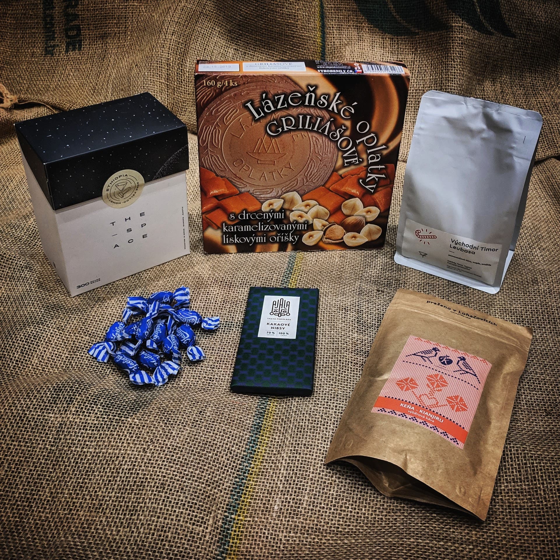 Assorted coffee packages and products on burlap background